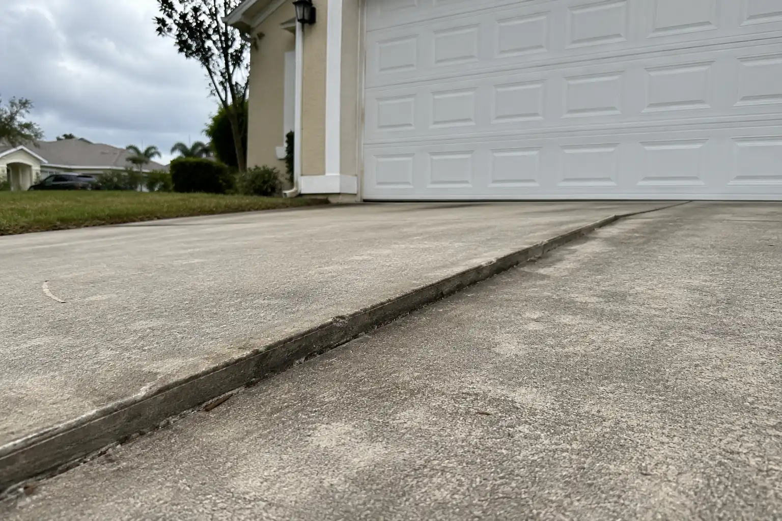 Sunken concrete slab sitting below its neighbor, forming a trip edge