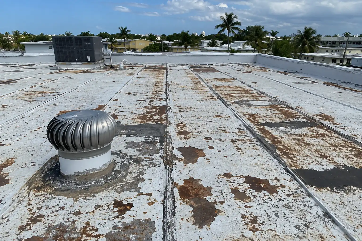 Metal roof with rust streaking and failing coating